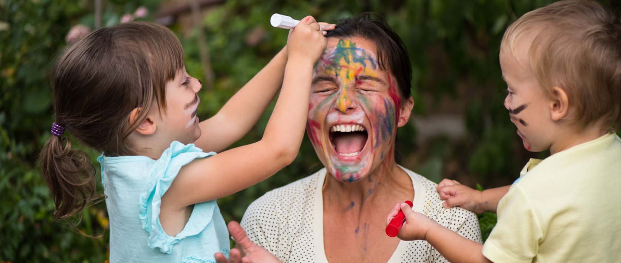 Children drawing on woman