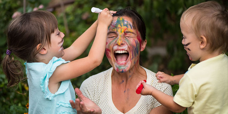 Children drawing on woman