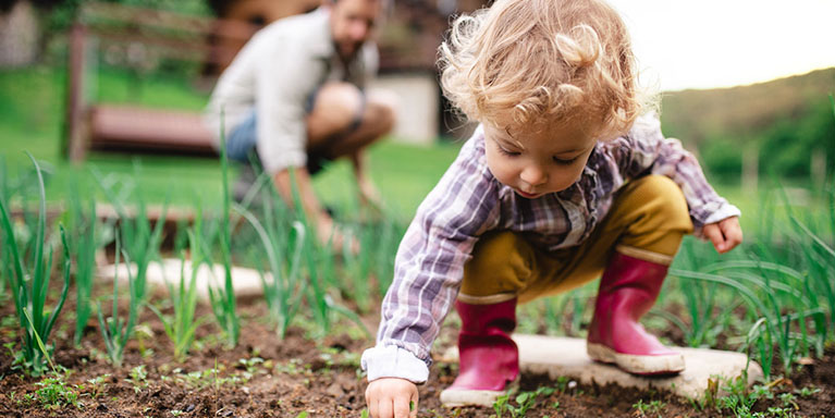Toddler playing in garden
