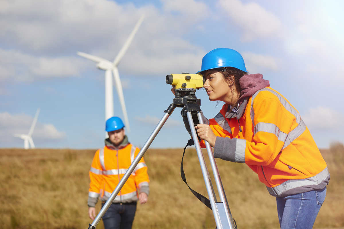 Woman surveying wind turbines