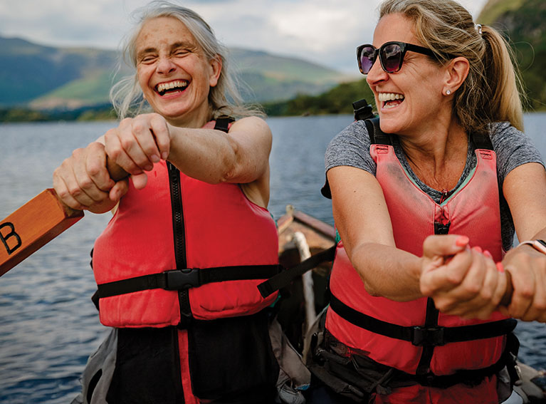 Two women in lifejackets rowing