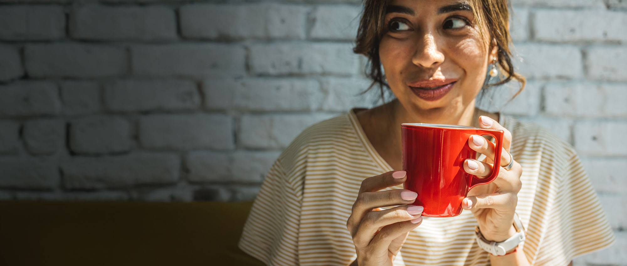 Happy woman holding red mug