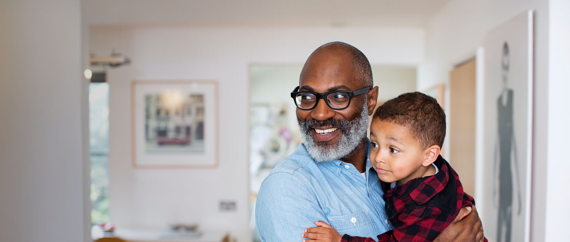 Man holding young child smiling