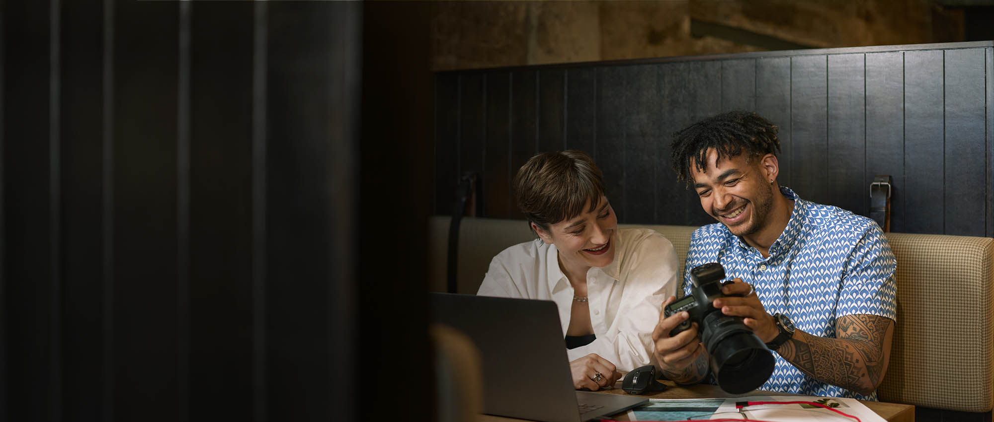 Man and woman looking at images on a camera