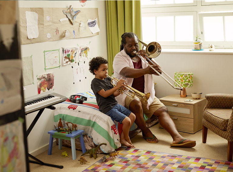 man and child playing the trumpet