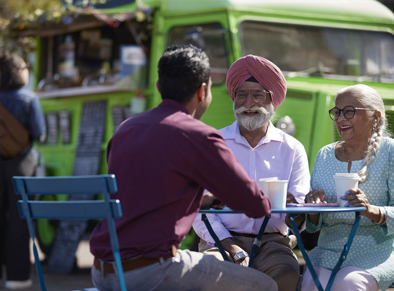 Family drinking coffee outside
