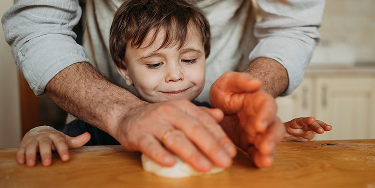 Child baking with parent