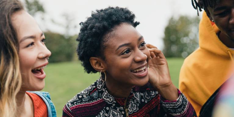 Woman with friends outside smiling