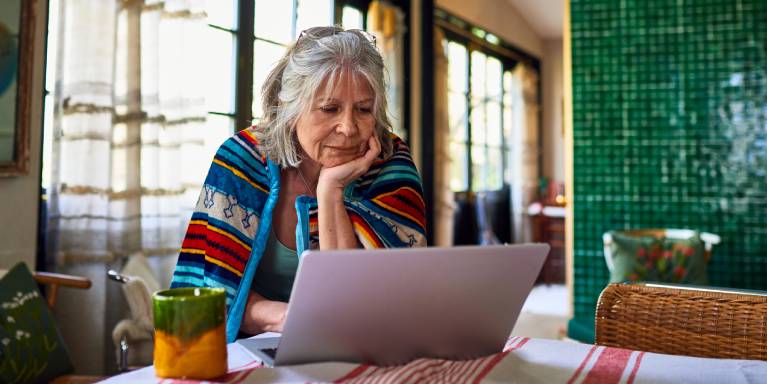 Woman looking at laptop pensively