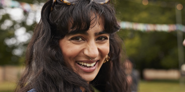 Woman with sunglasses on her head smiling