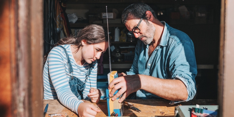 Father and daughter doing carpentry